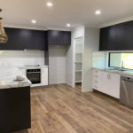 Black Cabinet In Modern Kitchen — Kitchen design in Paget, QLD